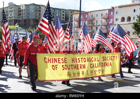 LOS ANGELES - FEBRUARY 9, 2019: The Chinese Historical Society of Southern California marches in the Chinese New Year Parade Carrying American Flags. Stock Photo