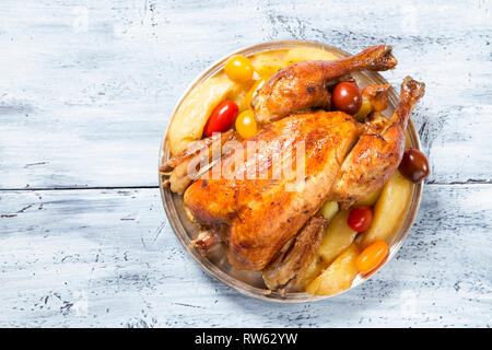 Roasted chicken garnished with vegetables - top view Stock Photo