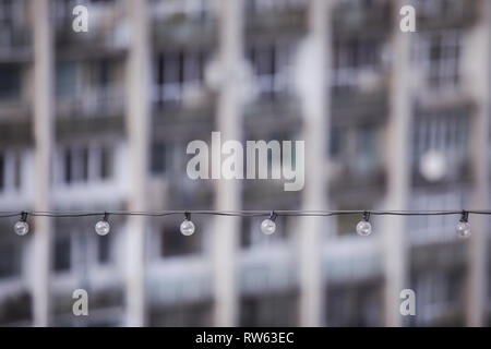 Turned off light bulbs in a row on a cable Stock Photo