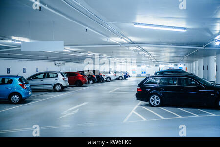 Karlsruhe, Germany - Oct 29, 2017: New underground parking in Schlossplatz blue tone colored parking with multiple cars parked Stock Photo