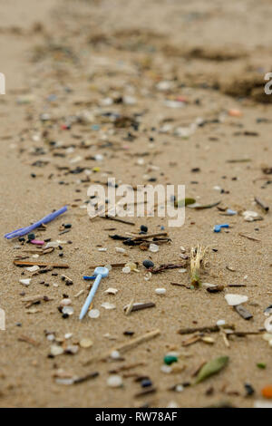 Swansea, UK. 5th March, 2019.  Stormy seas have washed up plastic pollution on to beaches at the Gower peninsula, near Swansea.  Millions of  small items included 'nurdles' which are used in the manufacture of plastic products were washed ashore during recent stormy conditions..  Credit: Gareth Llewelyn/Alamy Live News. Stock Photo