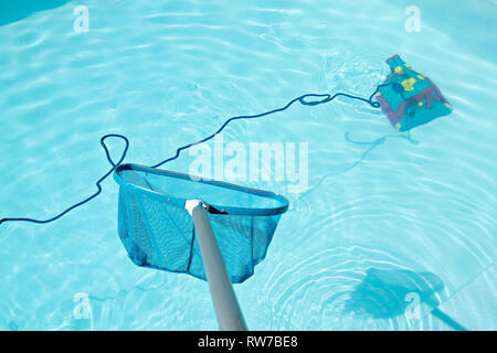Swimming pool cleaning with Pool Skimmer and underwater cleaning robot  Stock Photo - Alamy