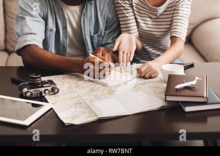 Couple planning vacation, making notes in diary Stock Photo