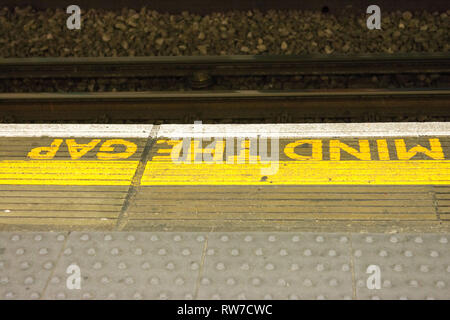 London uk, 2019-02-28. Mid the gap sign on Londons uderground train station Stock Photo