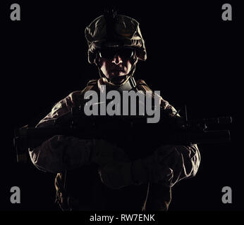 U.S. Marine with the rifle on black background. Stock Photo