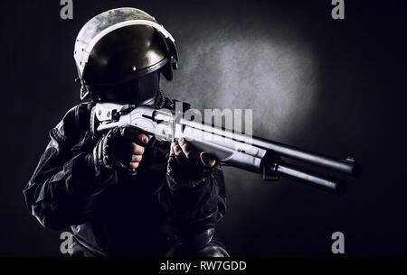 Spec ops soldier on black background with shotgun. Stock Photo