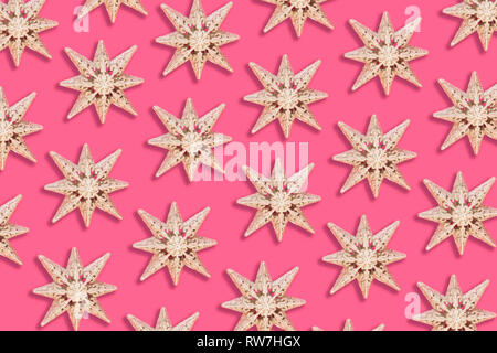 Holiday star pattern on pink background - flat lay Stock Photo