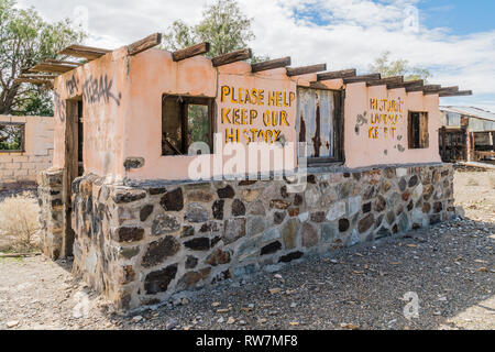Remains of building at the ghost town of Garlock, California. A building missing the roof, with concrete block walls that the lower half is rock facin Stock Photo