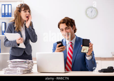 Deaf employee using hearing aid talking to boss Stock Photo