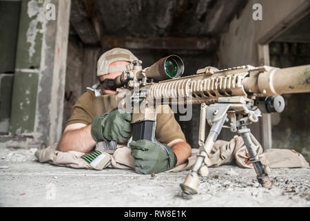 Navy Seal sniper with rifle in action. Stock Photo