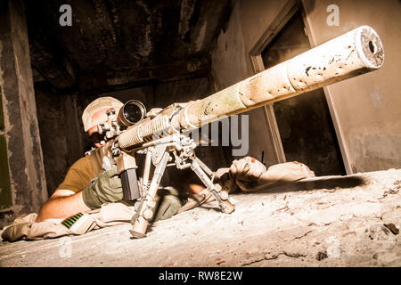 Navy Seal sniper with rifle in action. Stock Photo