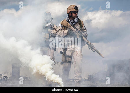 Navy SEALs Team with weapons in action. Stock Photo
