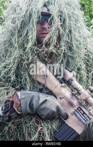 Navy Seal sniper with rifle in action. Stock Photo