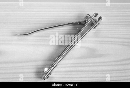 Top view of a nail cutter nail trimmer kept on a wooden table. Copy space provided Stock Photo