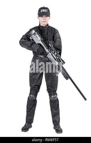 Female police officer, SWAT, in black uniform with sniper rifle, studio shot. Stock Photo