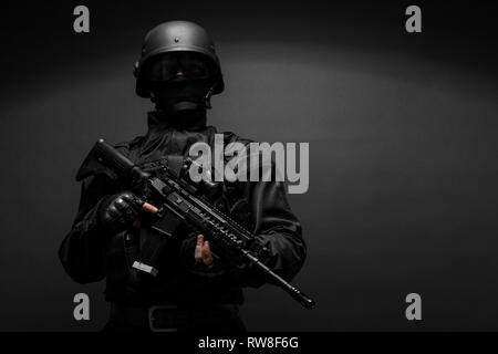 Spec ops police officer SWAT in black uniform. Stock Photo