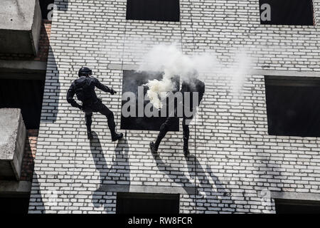 Spec ops police officers SWAT during assault operation. Stock Photo