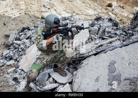 Member of Navy SEAL Team with weapons in action. Stock Photo