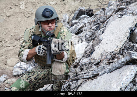 Member of Navy SEAL Team with weapons in action. Stock Photo