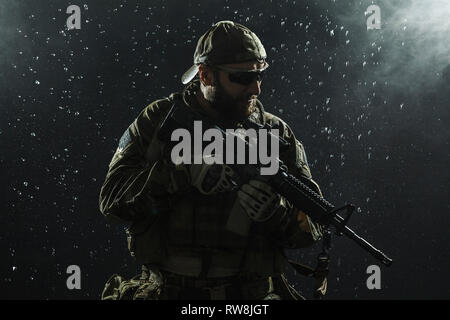 Green Berets U.S. Army Special Forces Group soldier in the rain. Stock Photo