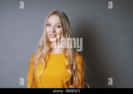 teenage girl with very long blond hair and beaming smile Stock Photo
