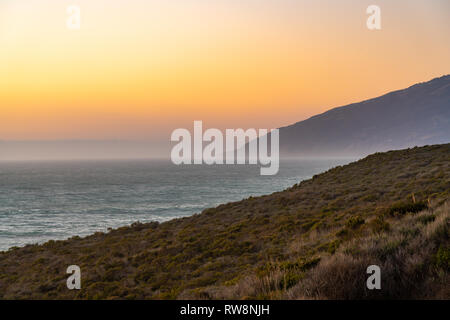 Big Sur, California - View of the natural California Coastline during a beautiful sunset along the Pacific Ocean. Stock Photo