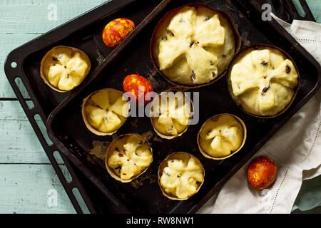 Preparation for baking, Easter raw bread. Easter cake and painted eggs on wooden table in rustic style. Stock Photo