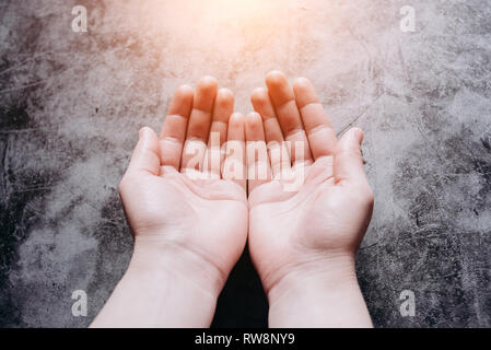 Female hands, offering help, protection and support symbol. Helping hand and hope concept and international day of peace Stock Photo