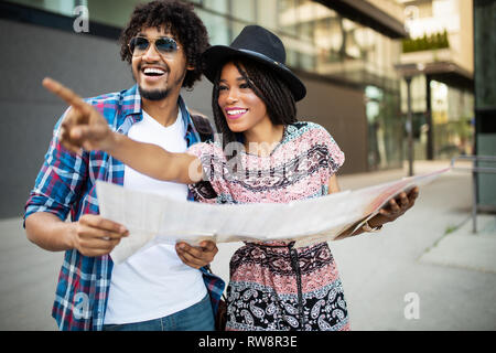 Happy black couple on vacation sightseeing city with map Stock Photo