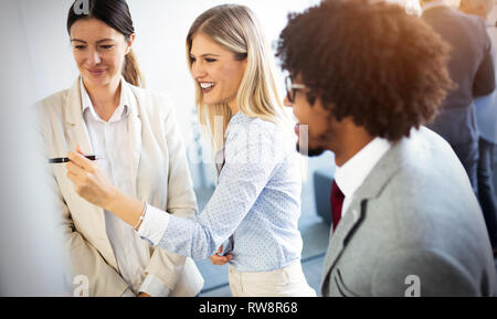 Diverse group of focused work colleagues during a planning and strategy meeting in office Stock Photo