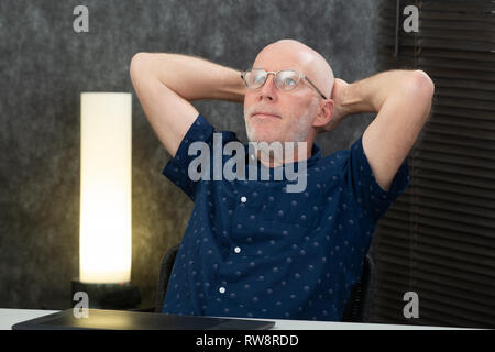 an handsome senior businessman relaxing in the office Stock Photo