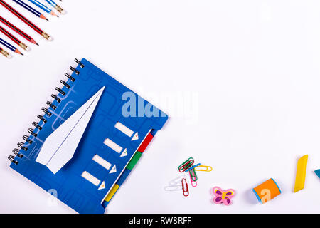 flat lay back to school . School notebook, a plane of paper and accessories on a white background Stock Photo