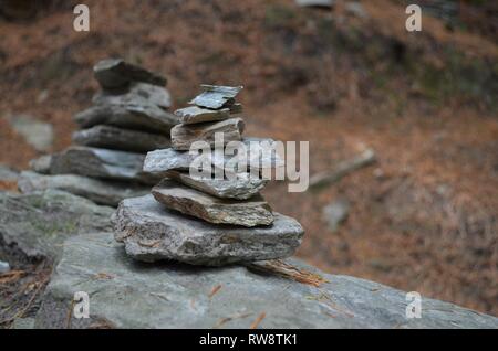 small mystic stone towers alone in the forest Stock Photo
