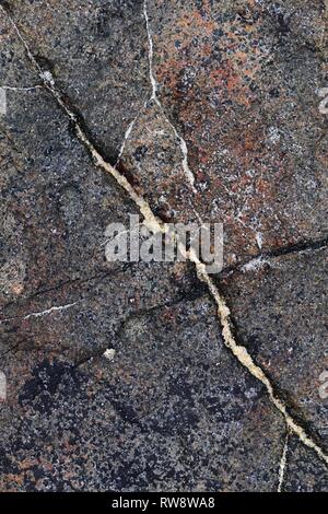 Close up texture of granite walls and rocks in high resolution with cracks and stunning structures Stock Photo