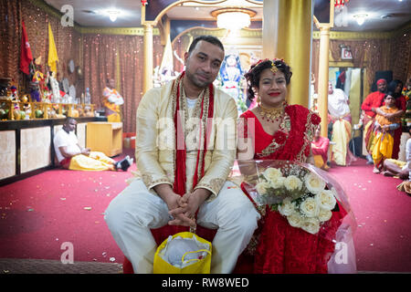 Posed portrait of a Hindu couple just prior to their wedding ceremony at a temple in Ozone Park, Queens, New York City. Stock Photo