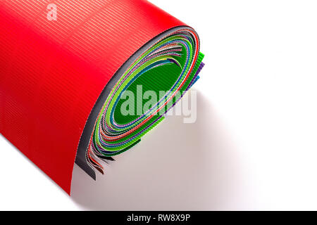 multi color cardboard corrugated papers rolled up on white Stock Photo