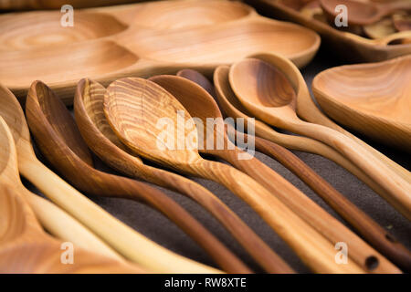 Close up of wooden utensils for the kitchen, bowls, spoons on dark background. Concept of natural dishes, a healthy lifestyle. Texture of wood. Wooden Stock Photo