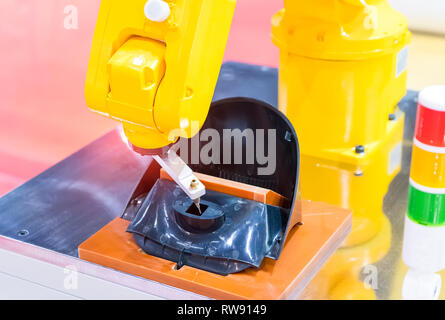 Robot holding glue syringe Injection Stock Photo