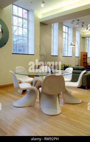 Glass dining table with chairs for sale in Heal's, Tottenham Court Road, London Stock Photo