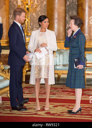 The Duke and Duchess of Sussex and the Princess Royal (right) attend a reception at Buckingham Palace in London to mark the fiftieth anniversary of the investiture of the Prince of Wales. Stock Photo