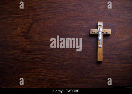 Funeral concept. Wooden cross on dark wooden background top view copy space Stock Photo