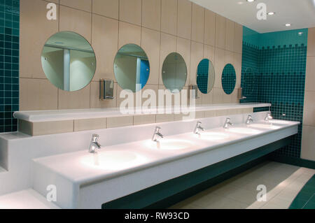 Mirrors and basins in a public restroom Stock Photo