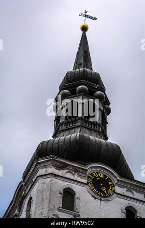 Baroque bell tower of lutheran St. Mary's Cathedral, also known as Dome Church, against grey cloudy sky in Tallinn, Estonia. Oldest church in Tallinn  Stock Photo