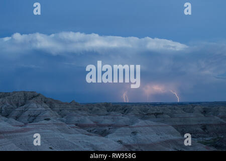 Multiple lightning strikes over the eerie landscape of the Badlands National Park. Stock Photo