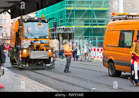 Wurzburg, Germany - 3 March 2019: workers cleaning dirty roads and city with automated cleaning trucks after the events of Fasching cultural carnival. Stock Photo