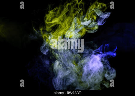 Fog colored with bright green and blue  gel on dark background Stock Photo