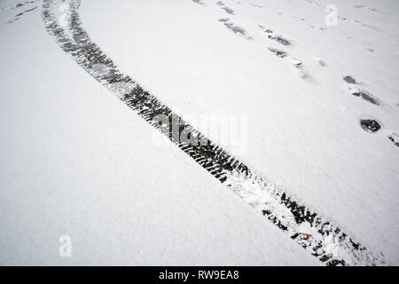 Car tyre tracks in snow Stock Photo