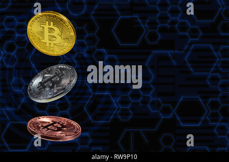 Bitcoin coins lavitate in mid air with blue circuit diagram as background Stock Photo