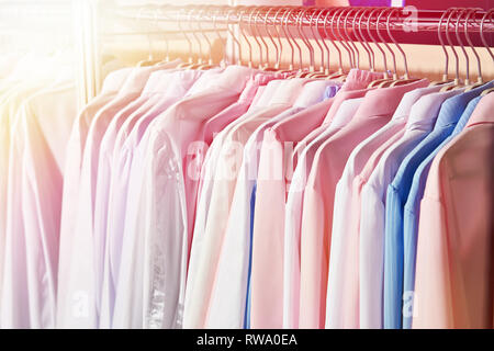 Women's blouses and shirts on the hanger in the store Stock Photo