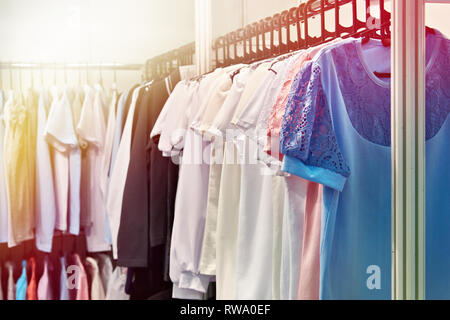 Women blouses and shirts on the hanger in the store Stock Photo